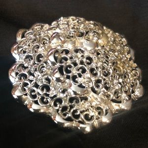 Intriguing silver tone round brooch